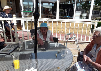 Residents enjoying some dominoes outside in the garden at Silverpoint Court