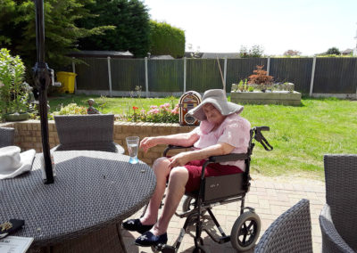 A resident enjoying some music outside in the garden at Silverpoint Court