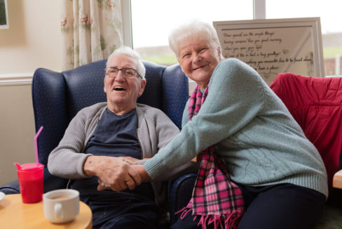 Husband and wife smiling at the camera at Silverpoint Court Residential Care Home