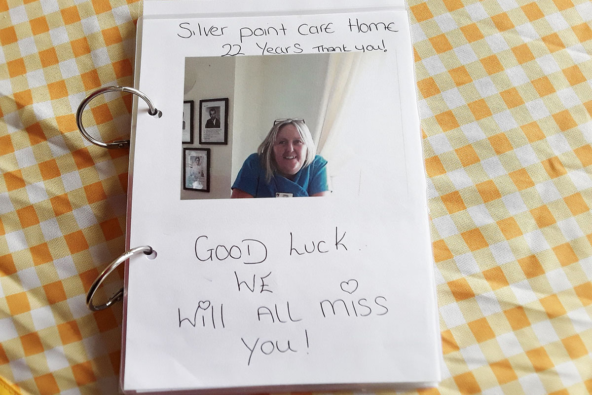 The front of a book of farewell photos and messages for a staff member leaving Silverpoint Court