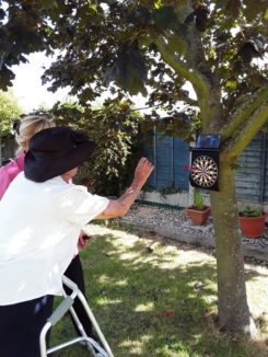 Resident playing darts in the garden at Silverpoint Court Residential Care Home