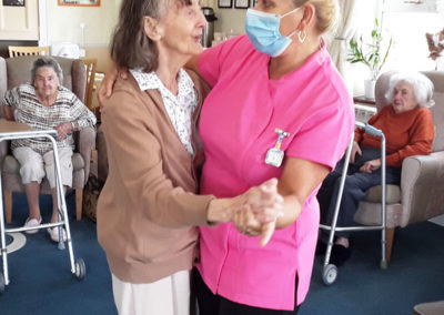 Lady resident and staff member dancing together at Silverpoint Court Residential Care Home