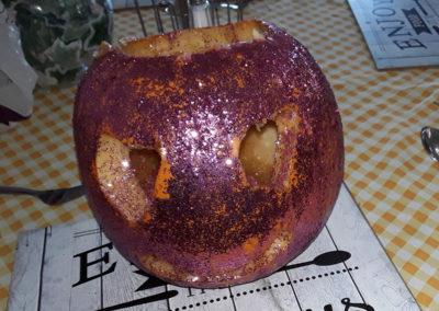 A pumpkin covered in purple glitter