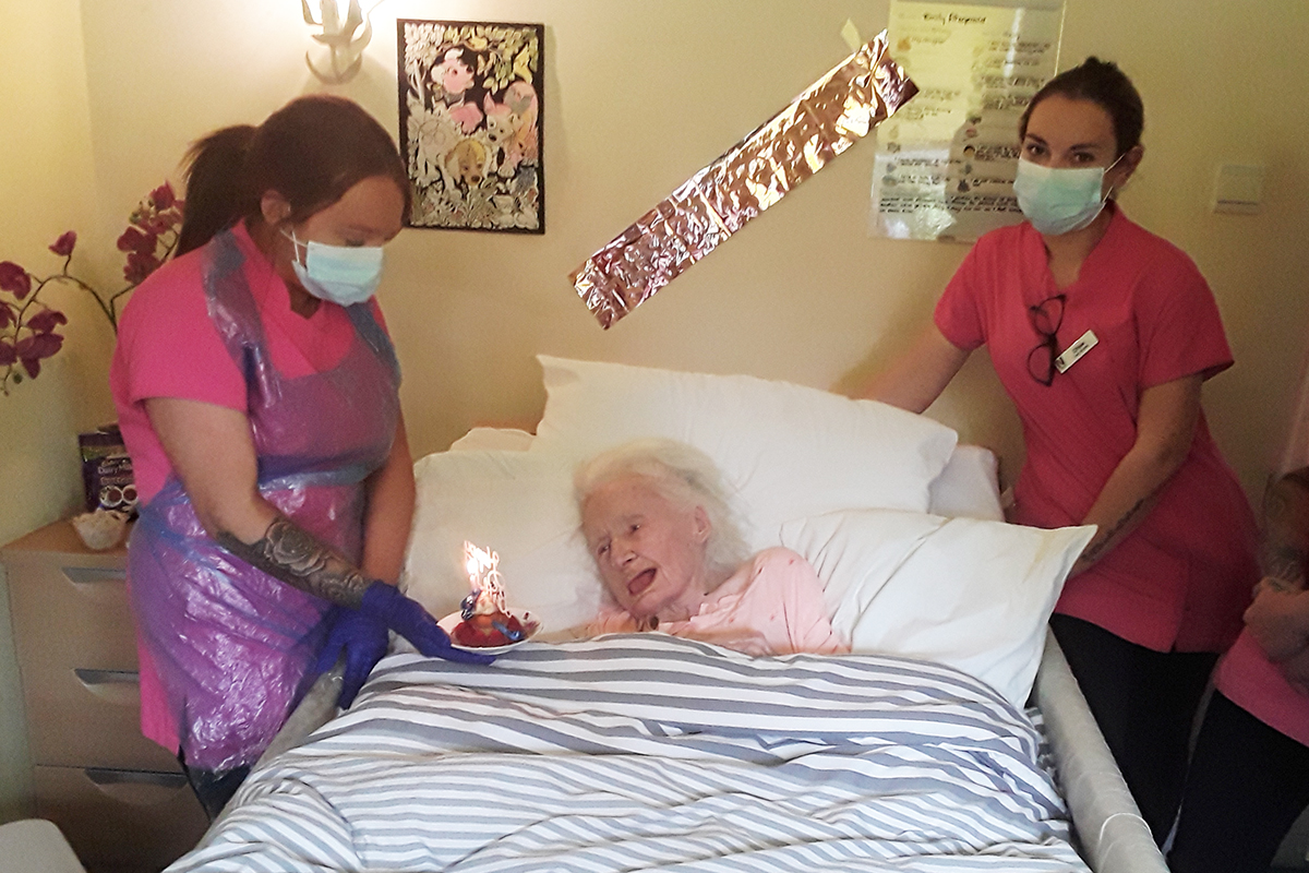 Silverpoint Court Residential Care Home resident receiving her birthday cake from staff