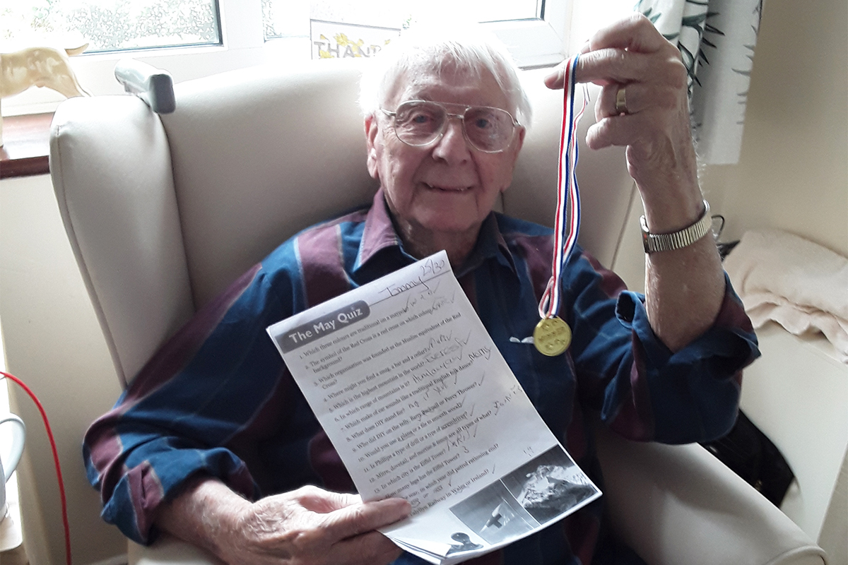 Silverpoint Court Residential Care Home resident with his Quiz winner medal