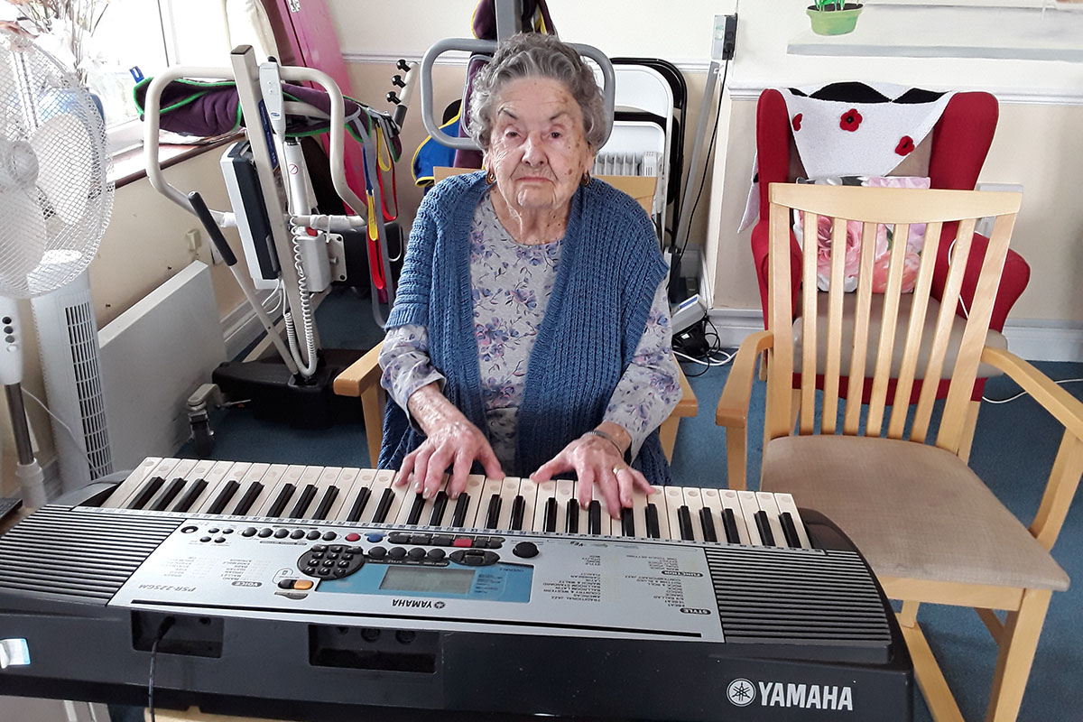 Silverpoint Court Residential Care Home lady resident playing the piano