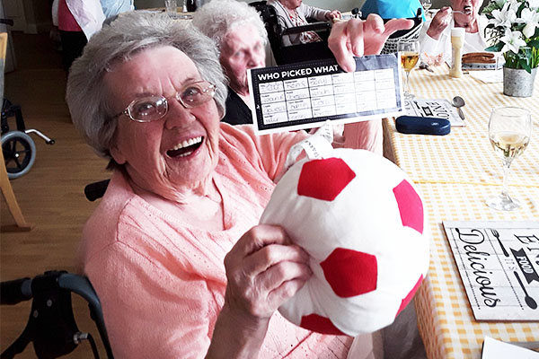 Silverpoint Court Residential Care Home resident with her prize ball after winning a football sweepstake