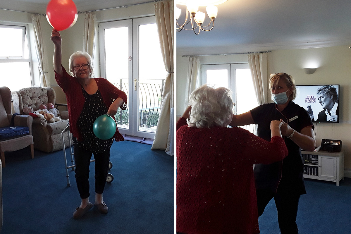Silverpoint Court Residential Care Home resident dancing and moving with balloons to music