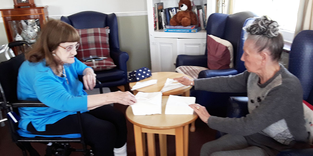 Silverpoint Court Residential Care Home residents helping with napkin folding